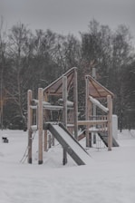 a playground in the snow with a slide