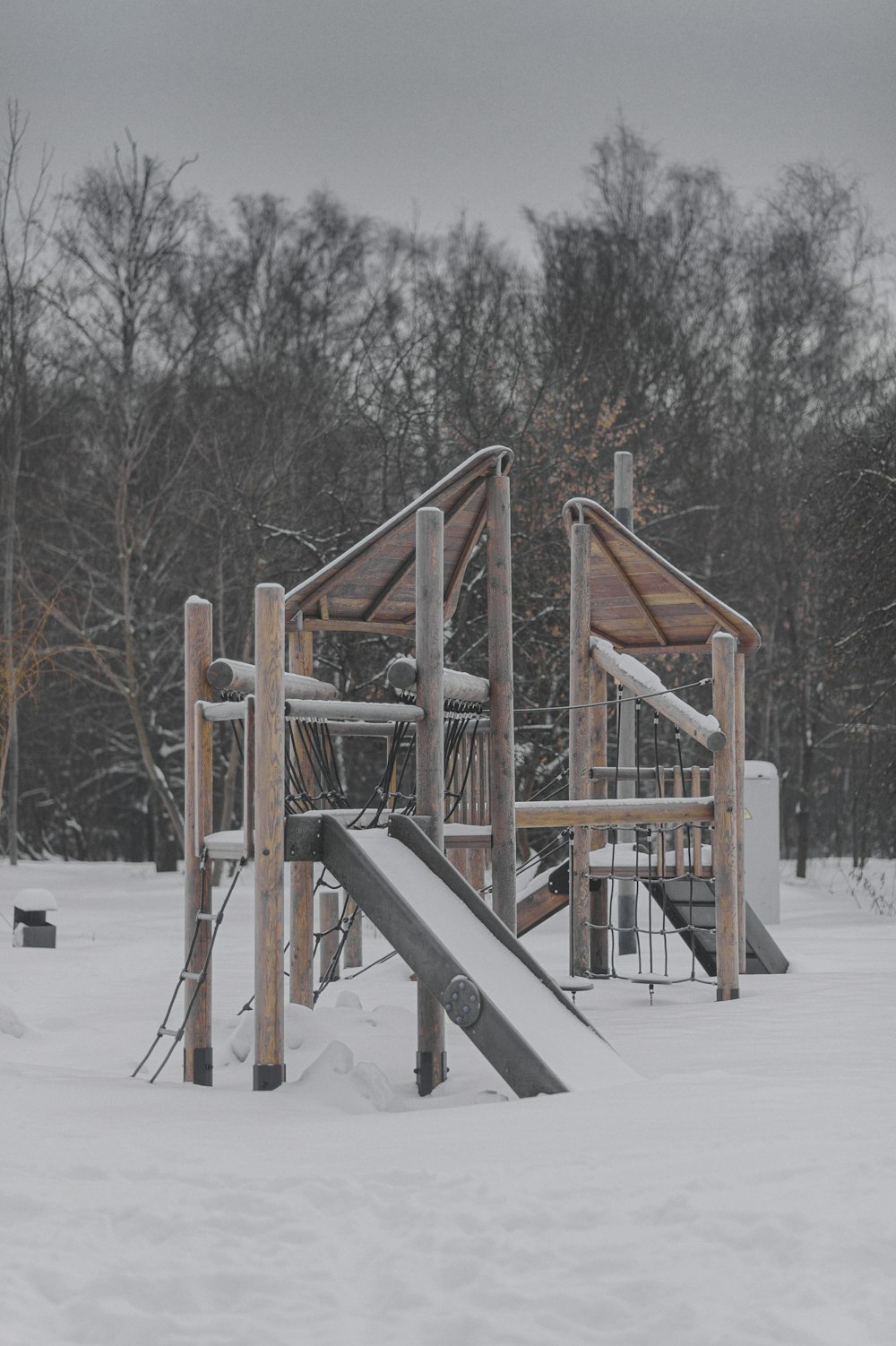 a playground in the snow with a slide