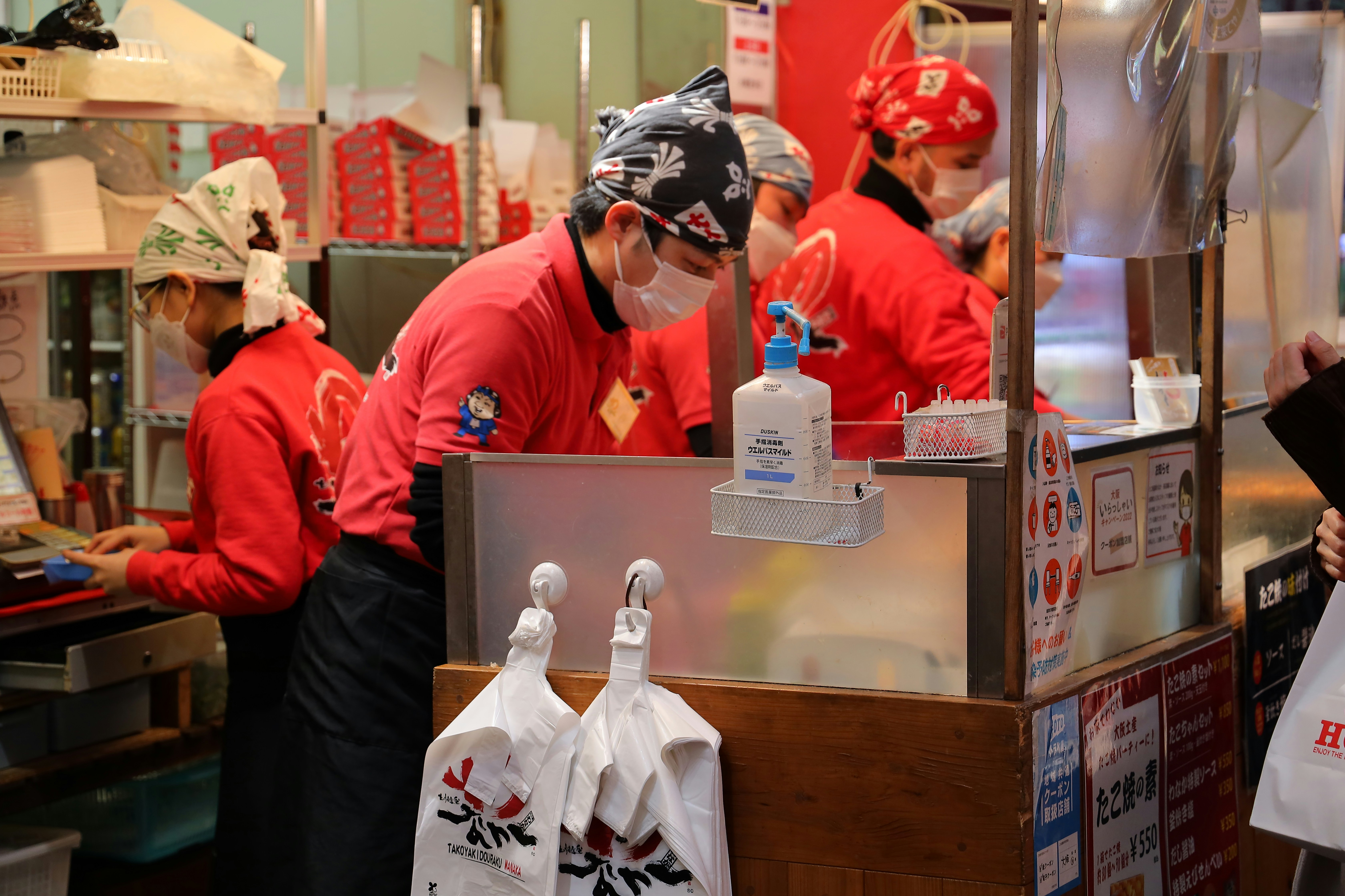a group of people in a kitchen preparing food, 