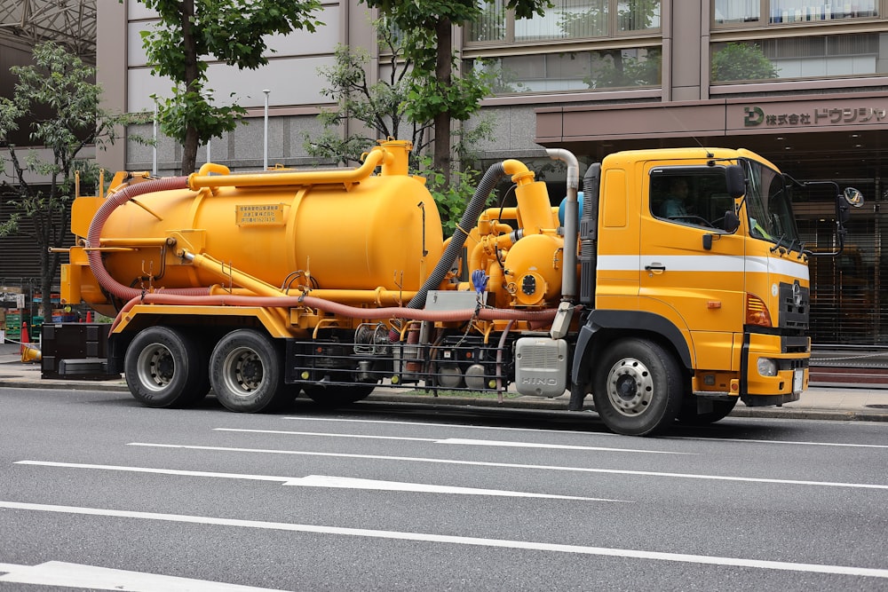 a large yellow truck parked on the side of the road