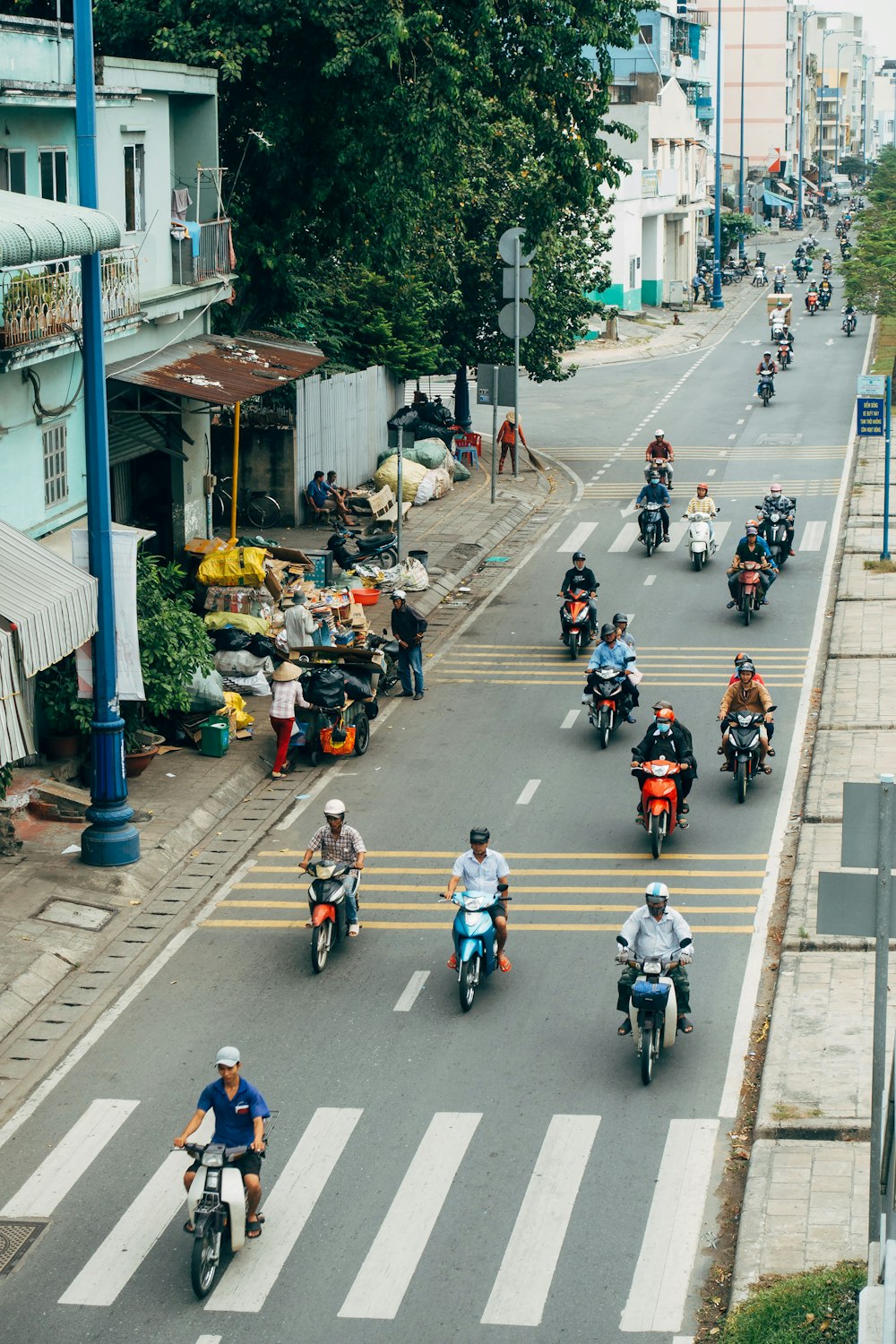 a group of people riding motorcycles down a street