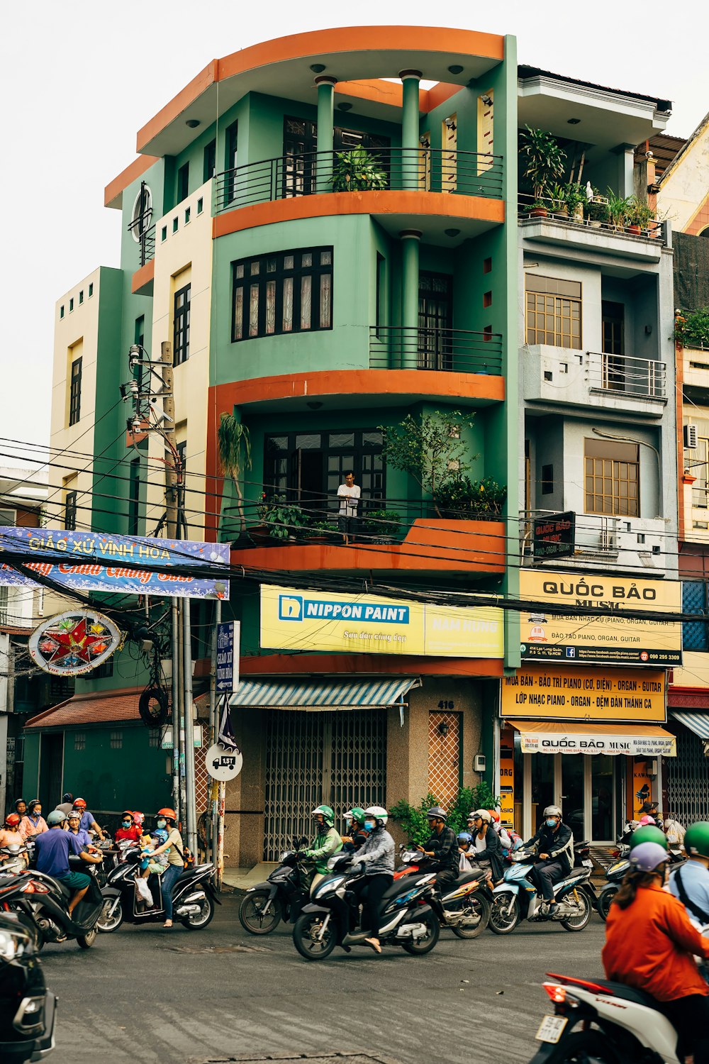 a group of people riding motorcycles down a street