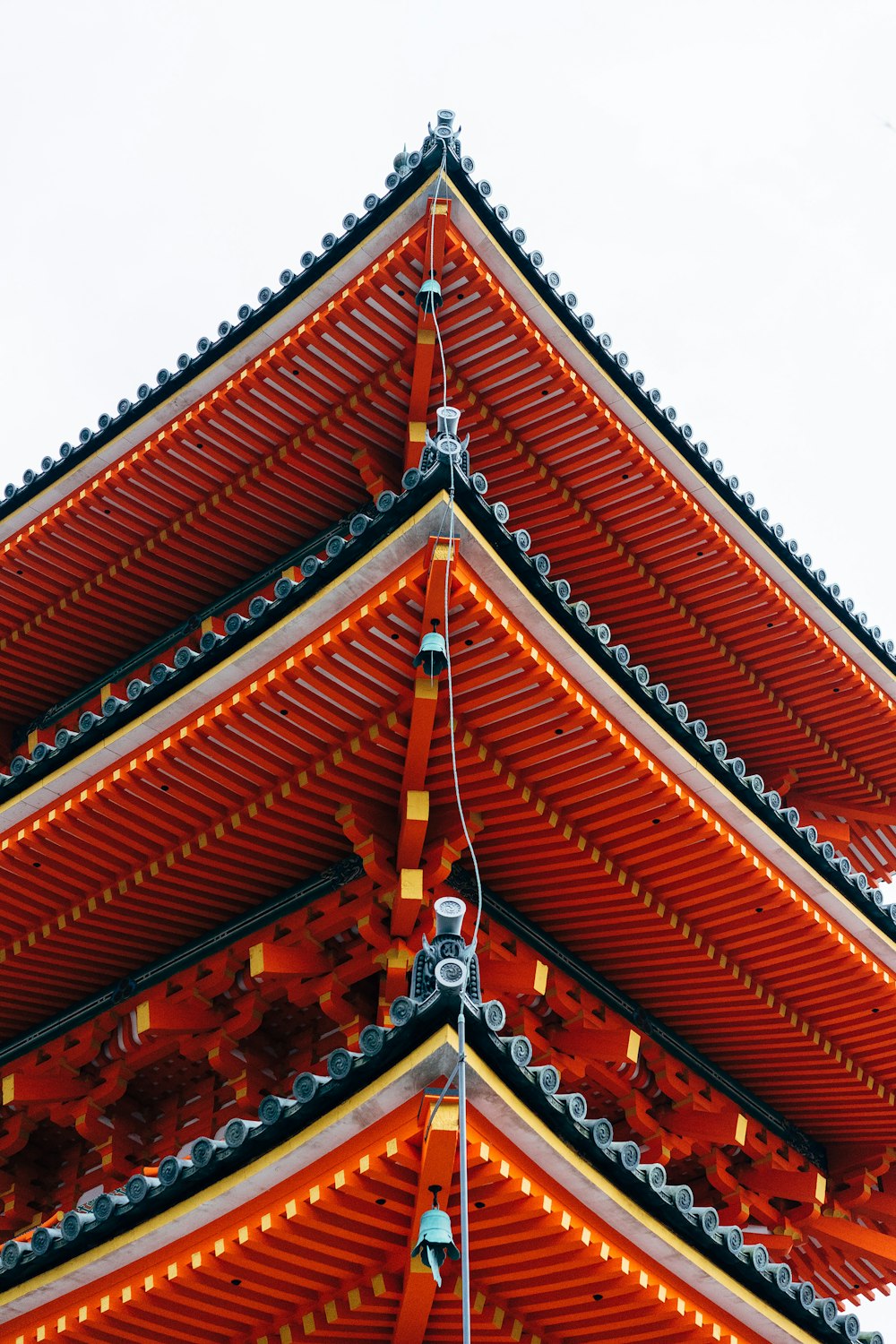 a tall red and yellow building with a sky background