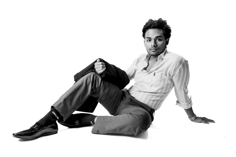 a man sitting on the ground with his legs crossed