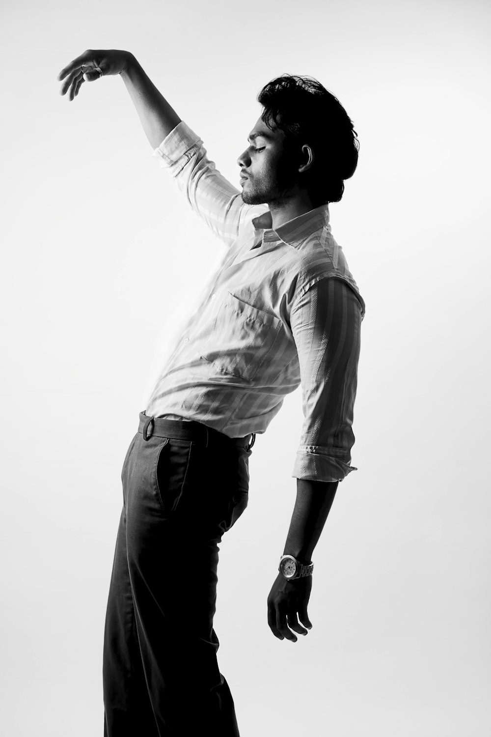 a man standing on a skateboard in a black and white photo