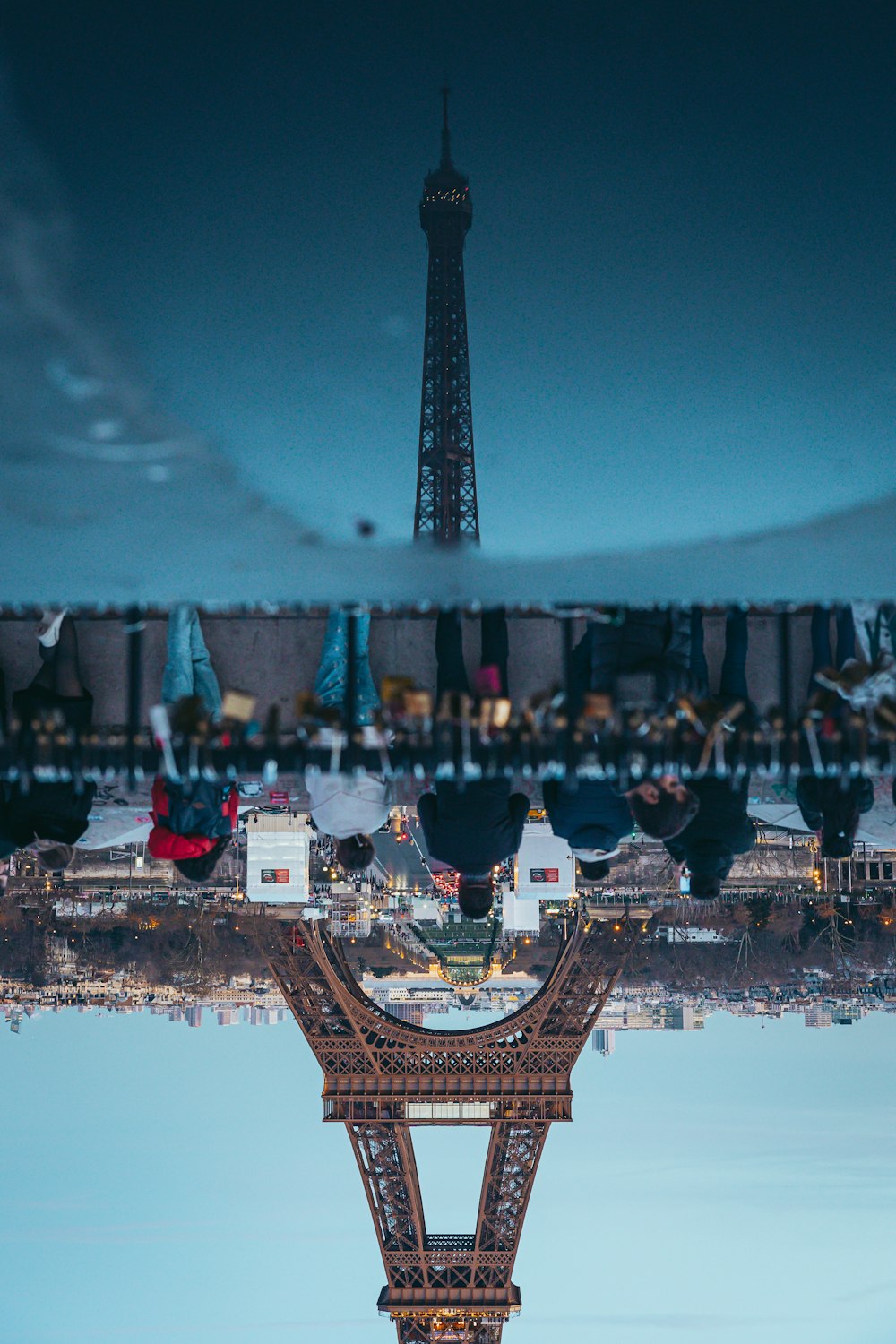 the eiffel tower is reflected in the water