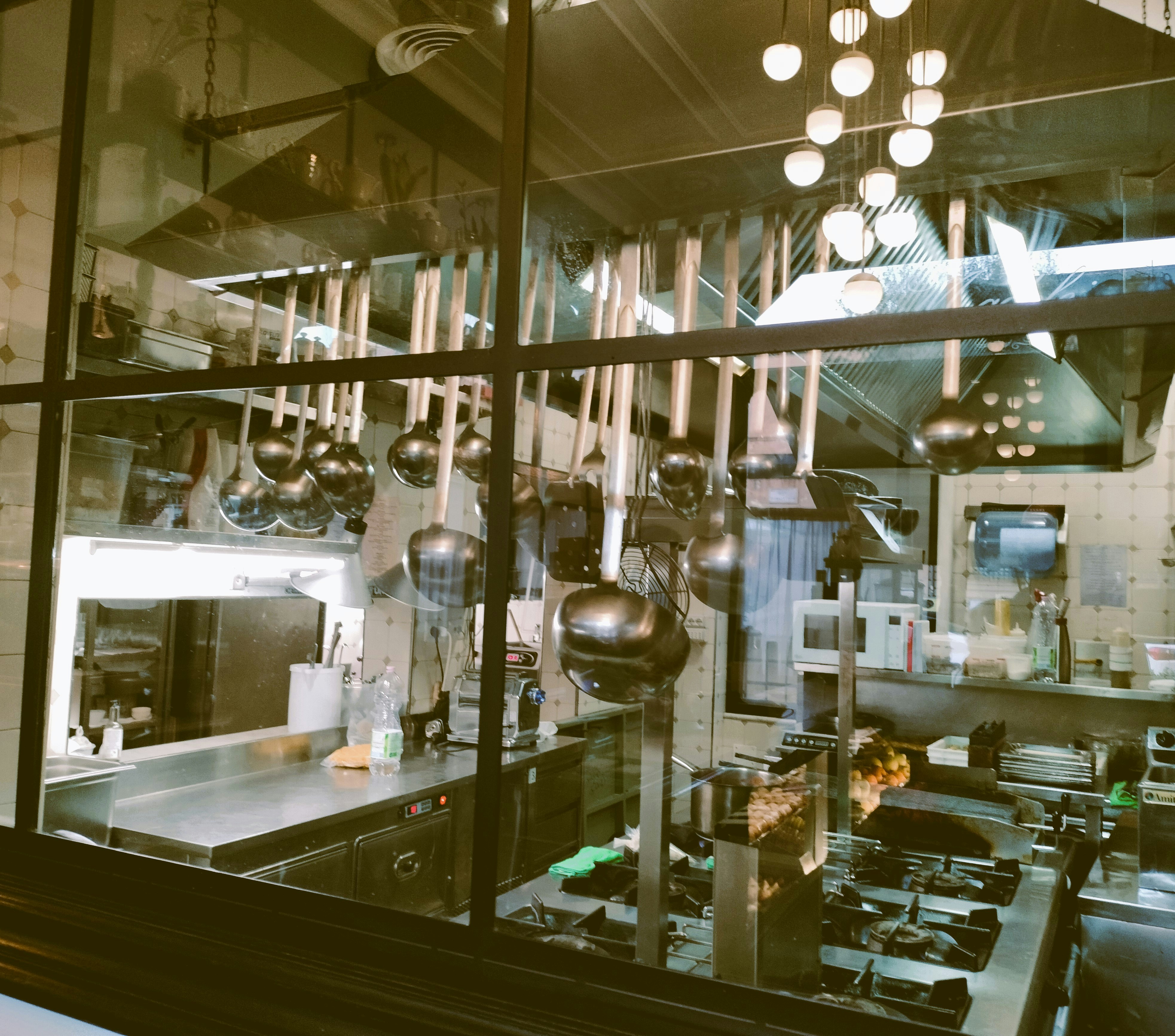 Stainless steel commercial kitchen with cooking equipment and prep area