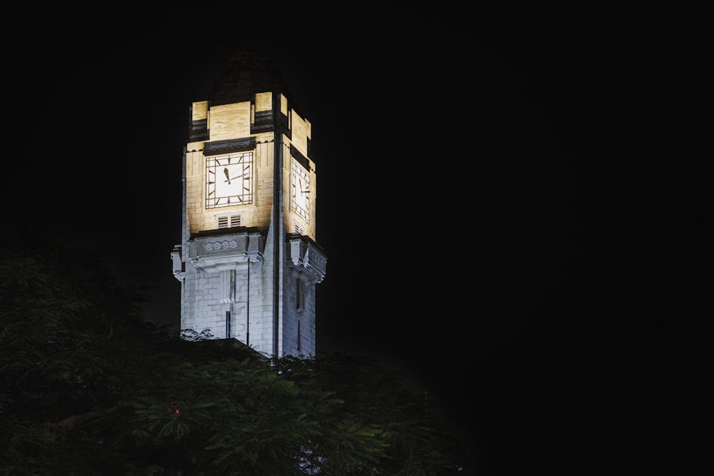 a tall clock tower lit up at night