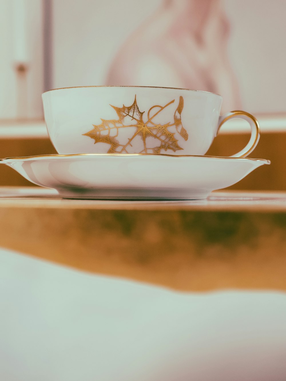 a cup and saucer sitting on a table