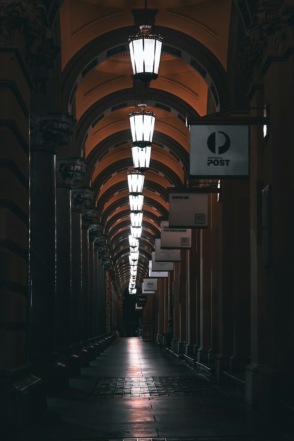 a long hallway with lights on either side of it