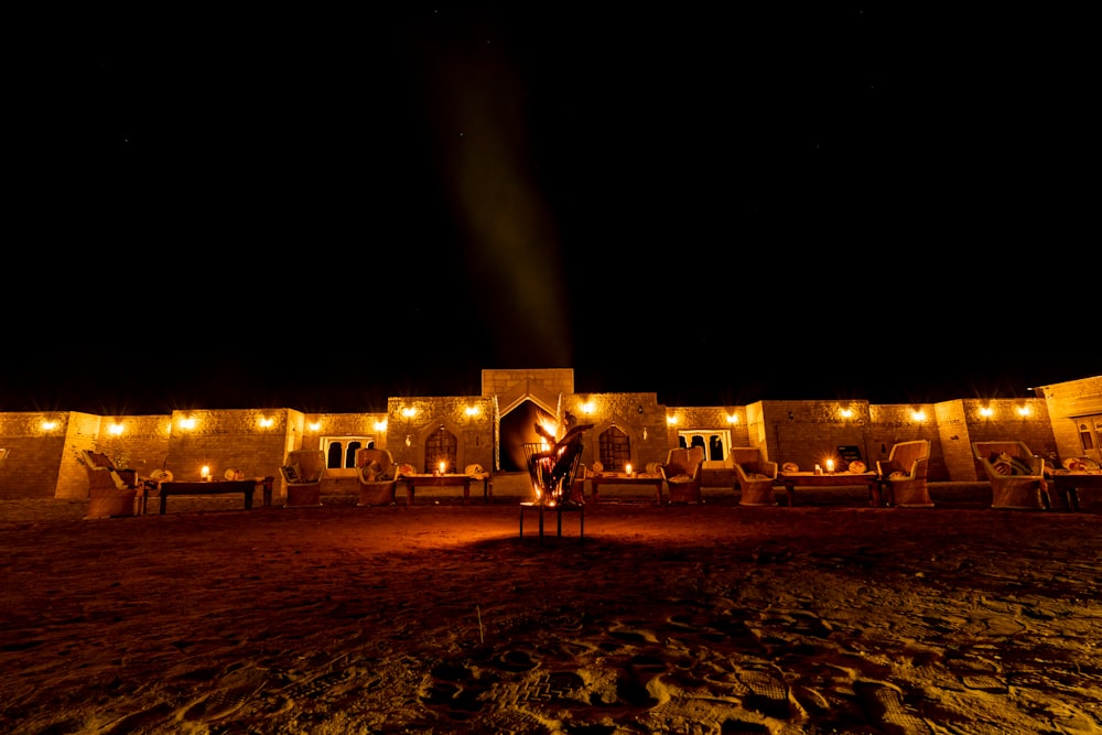 a person standing in front of a building at night