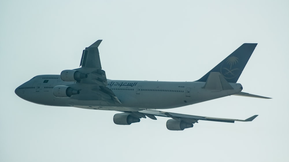 a large jetliner flying through a cloudy sky