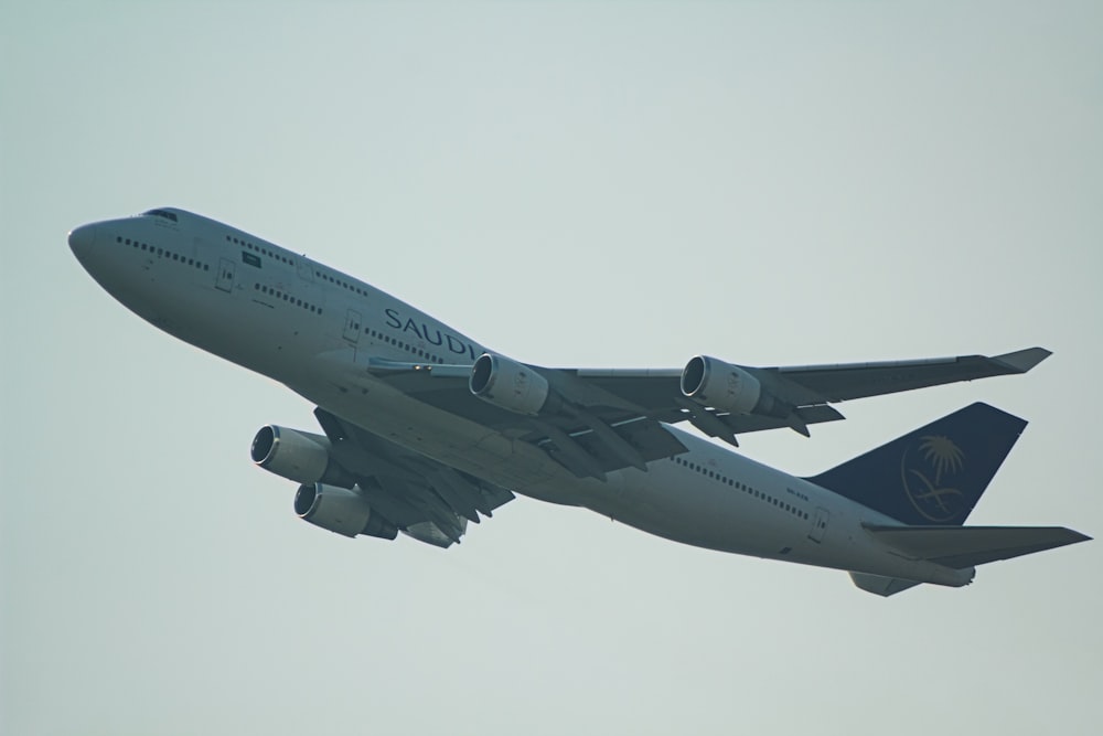 a large jetliner flying through a cloudy sky