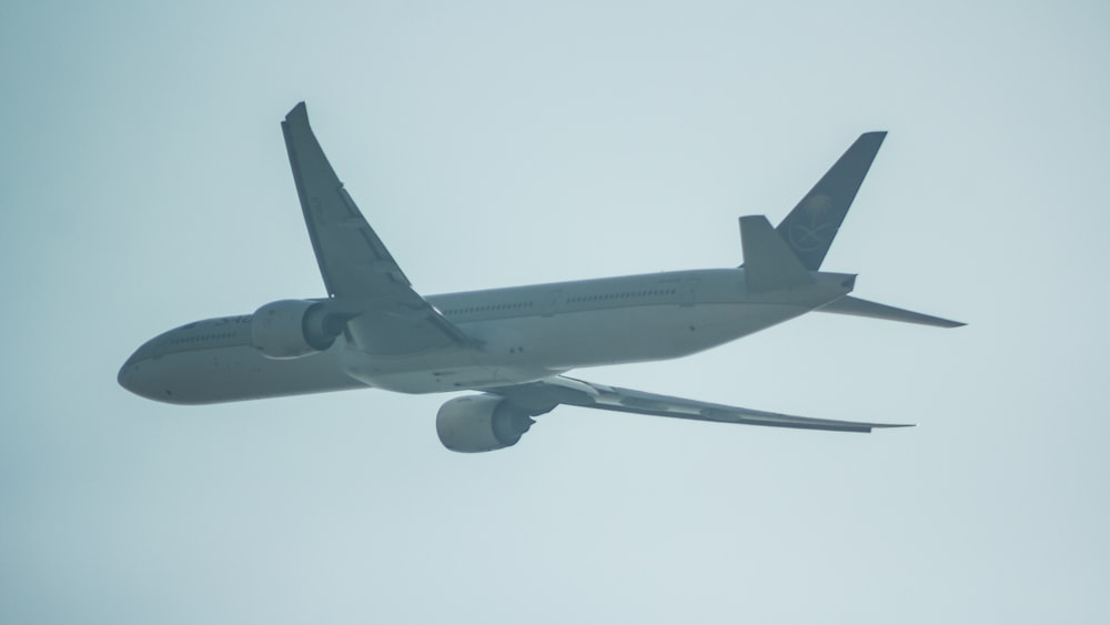 a large jetliner flying through a cloudy sky