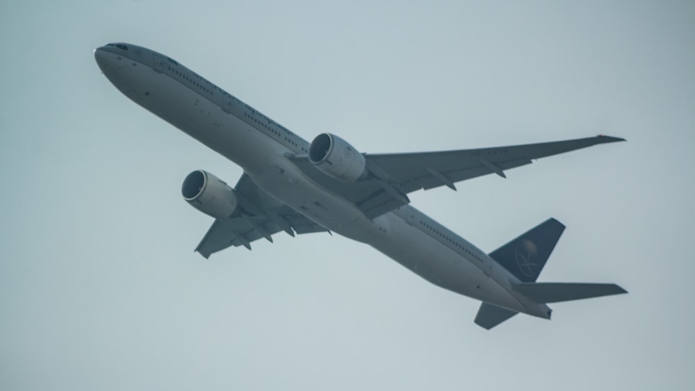 a large jetliner flying through a cloudy sky