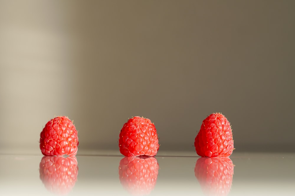 a group of raspberries sitting on top of a table