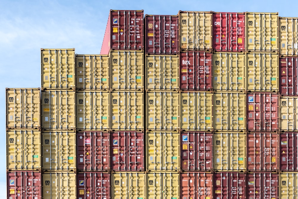 a large stack of shipping containers stacked on top of each other