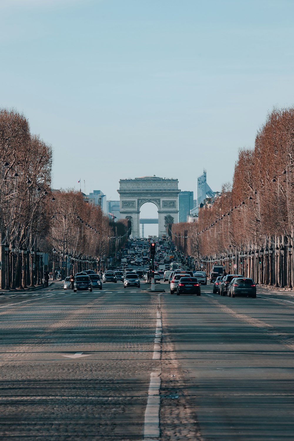 a city street lined with trees and a traffic light