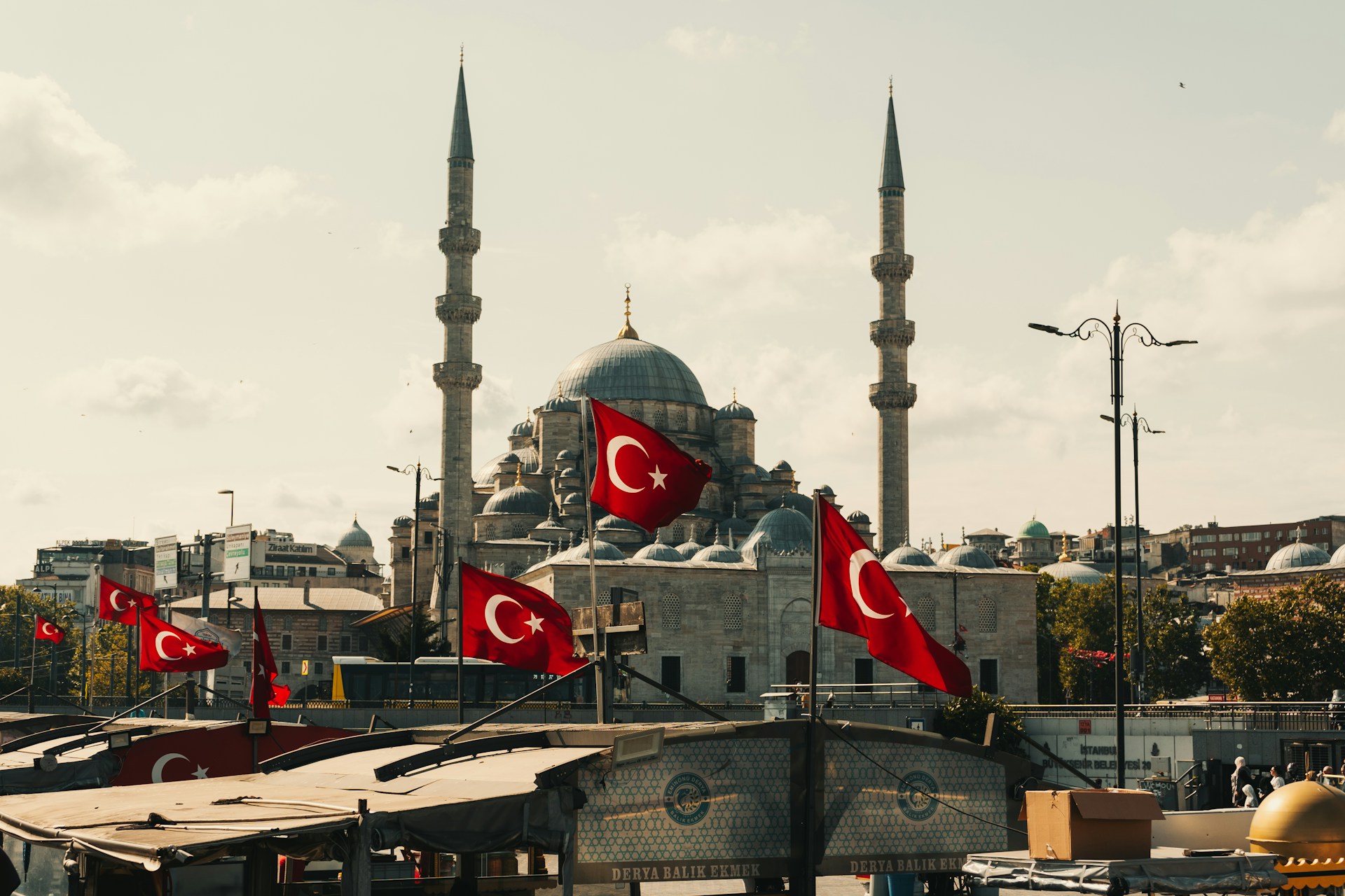 a group of flags flying in front of a building