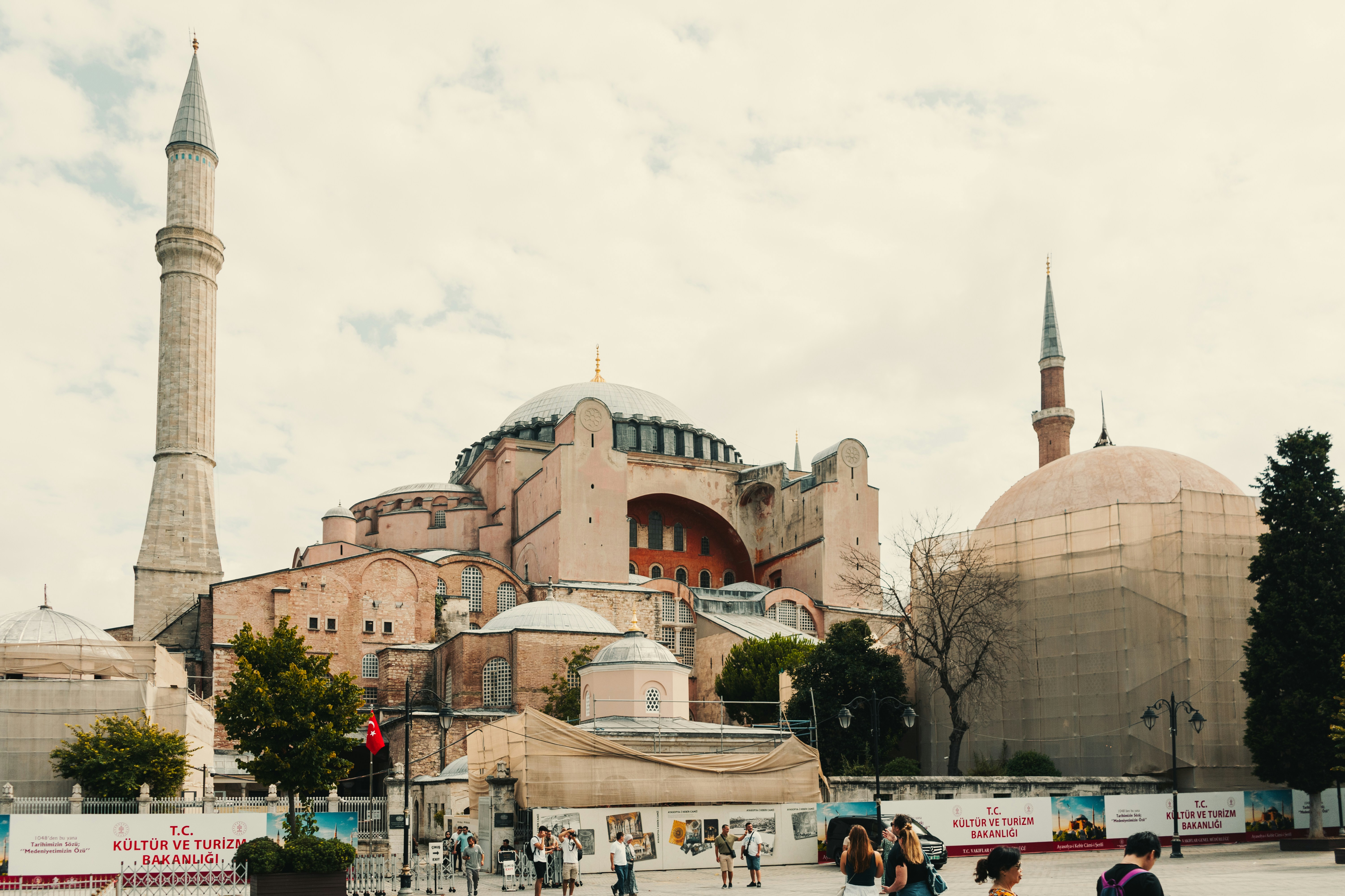 a group of people standing in front of a building, 