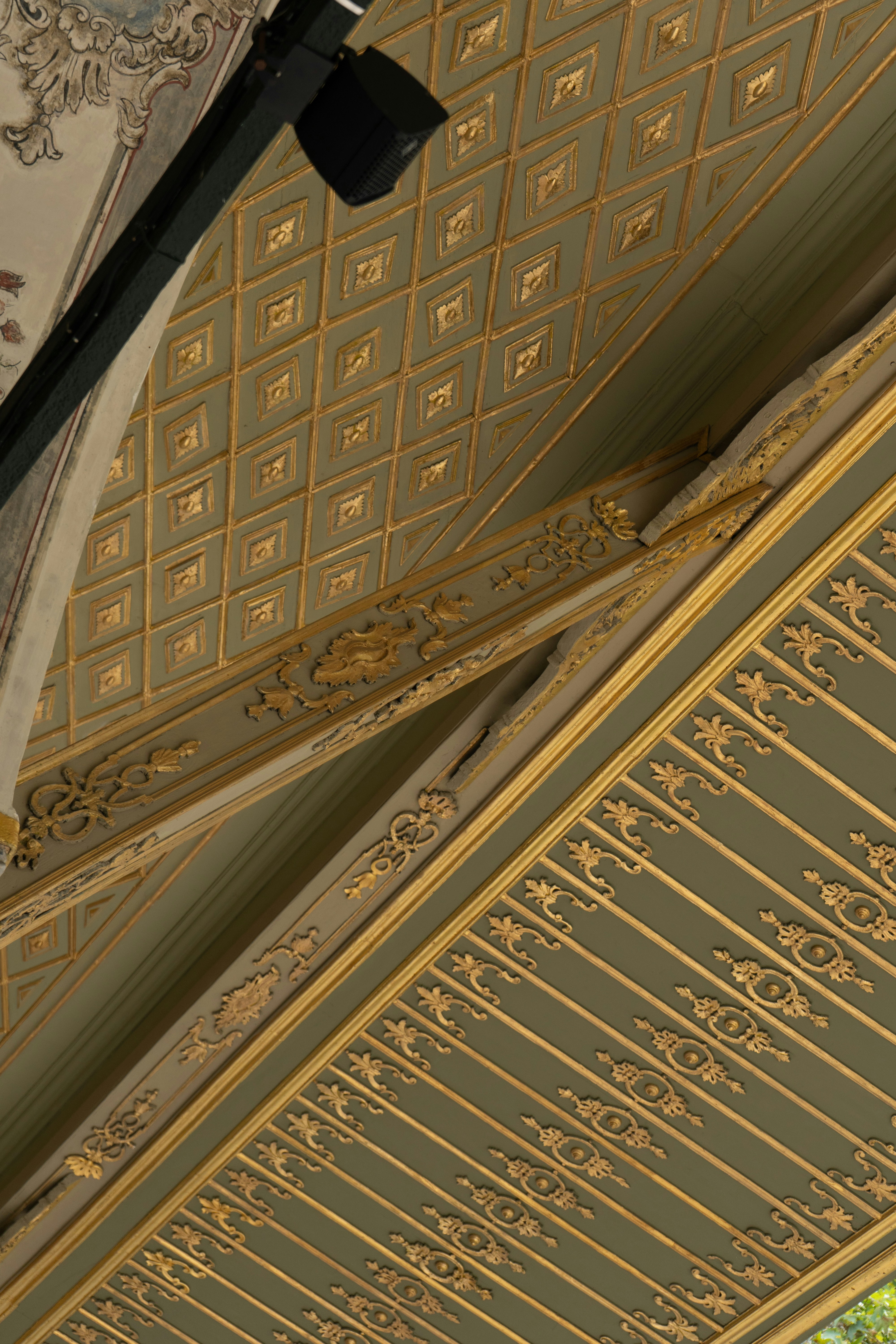 the ceiling of a building with a clock on it