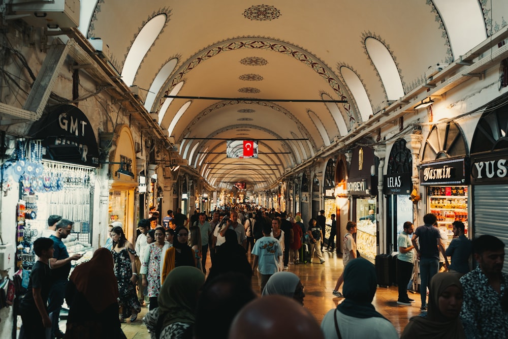 a crowd of people walking through a train station