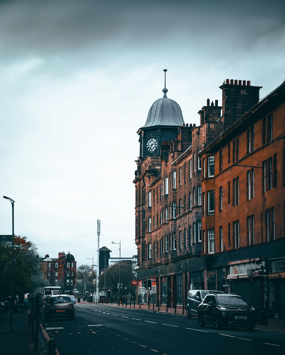 a clock tower on top of a building on a city street