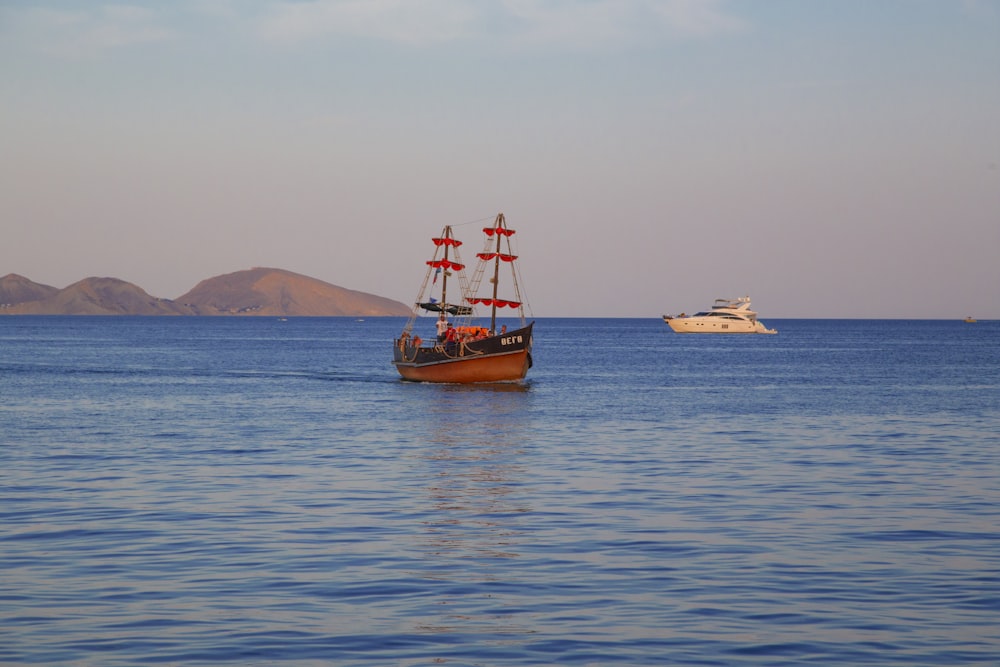 a boat sailing in the middle of a large body of water