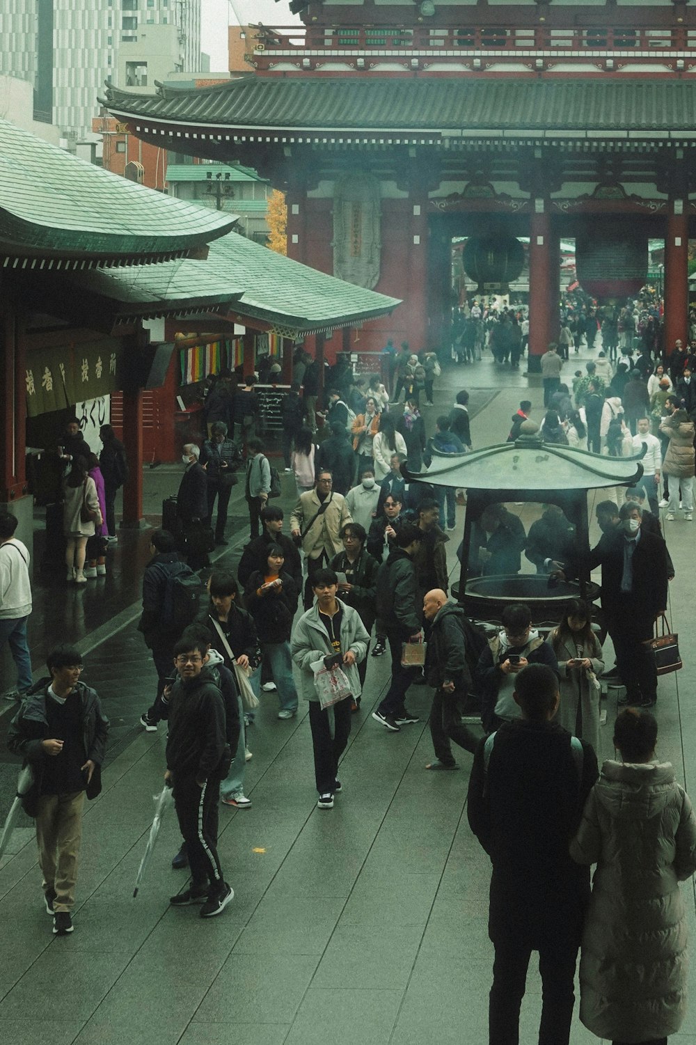 a group of people walking down a street next to a building