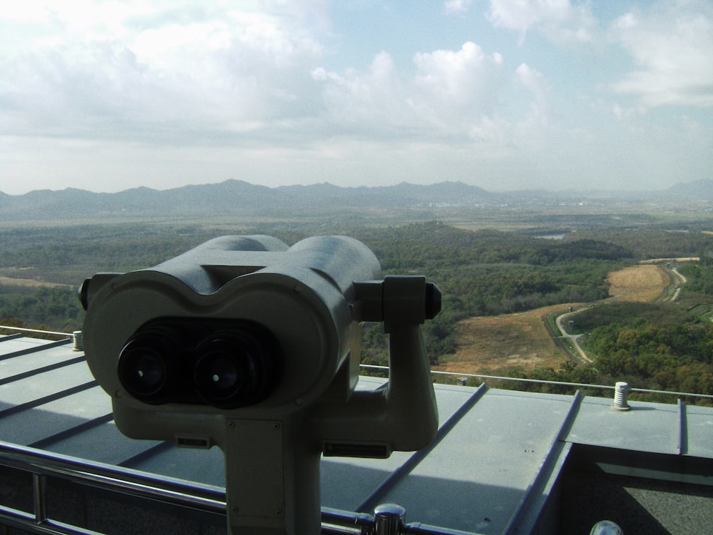 a telescope on top of a building overlooking a valley