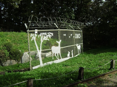 a fence with a picture of animals on it
