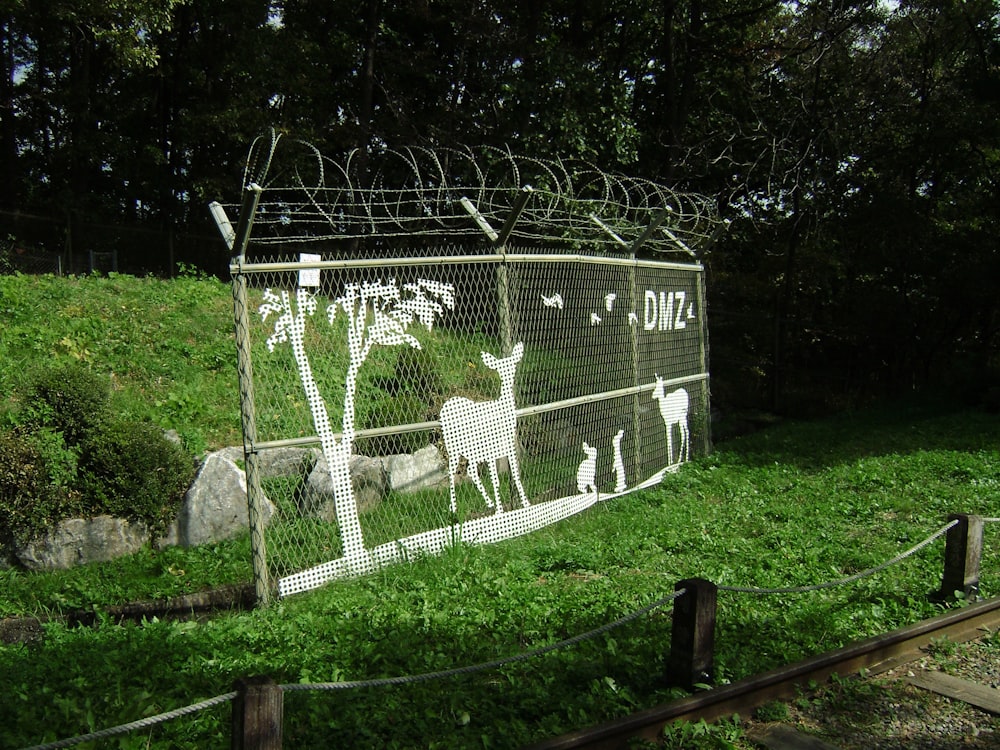 a fence with a picture of animals on it