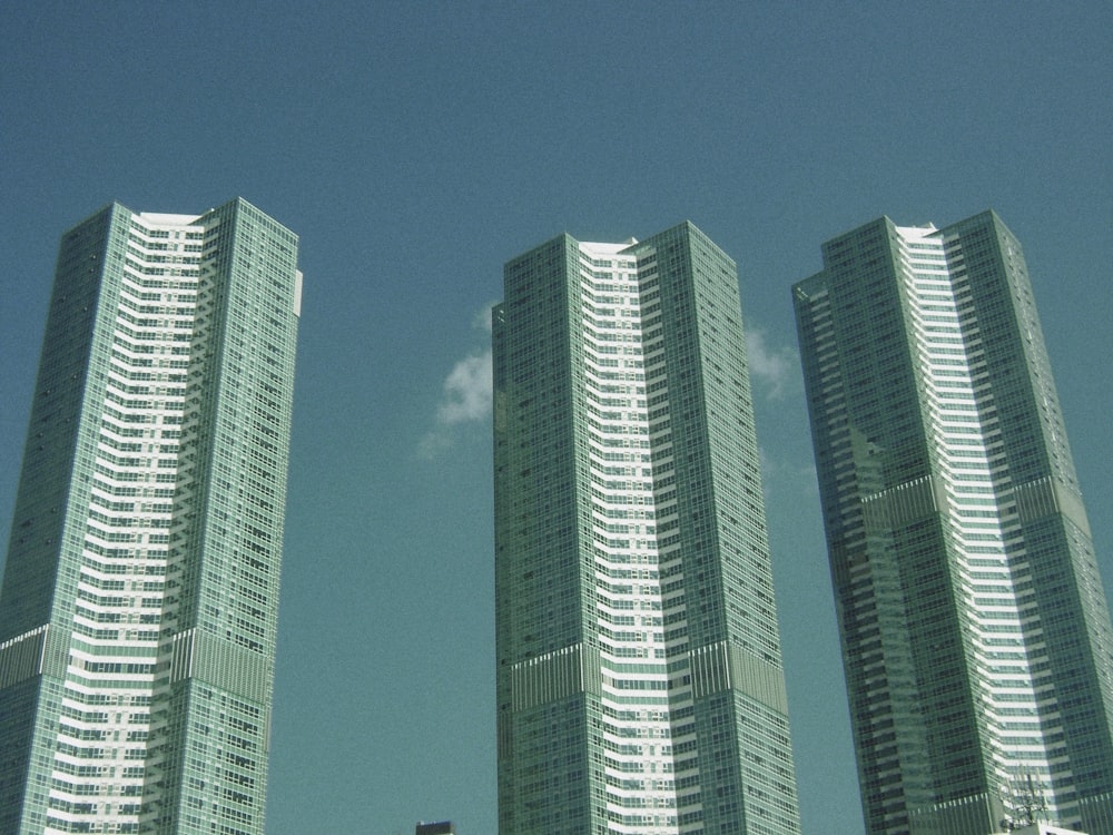 a couple of tall buildings sitting next to each other