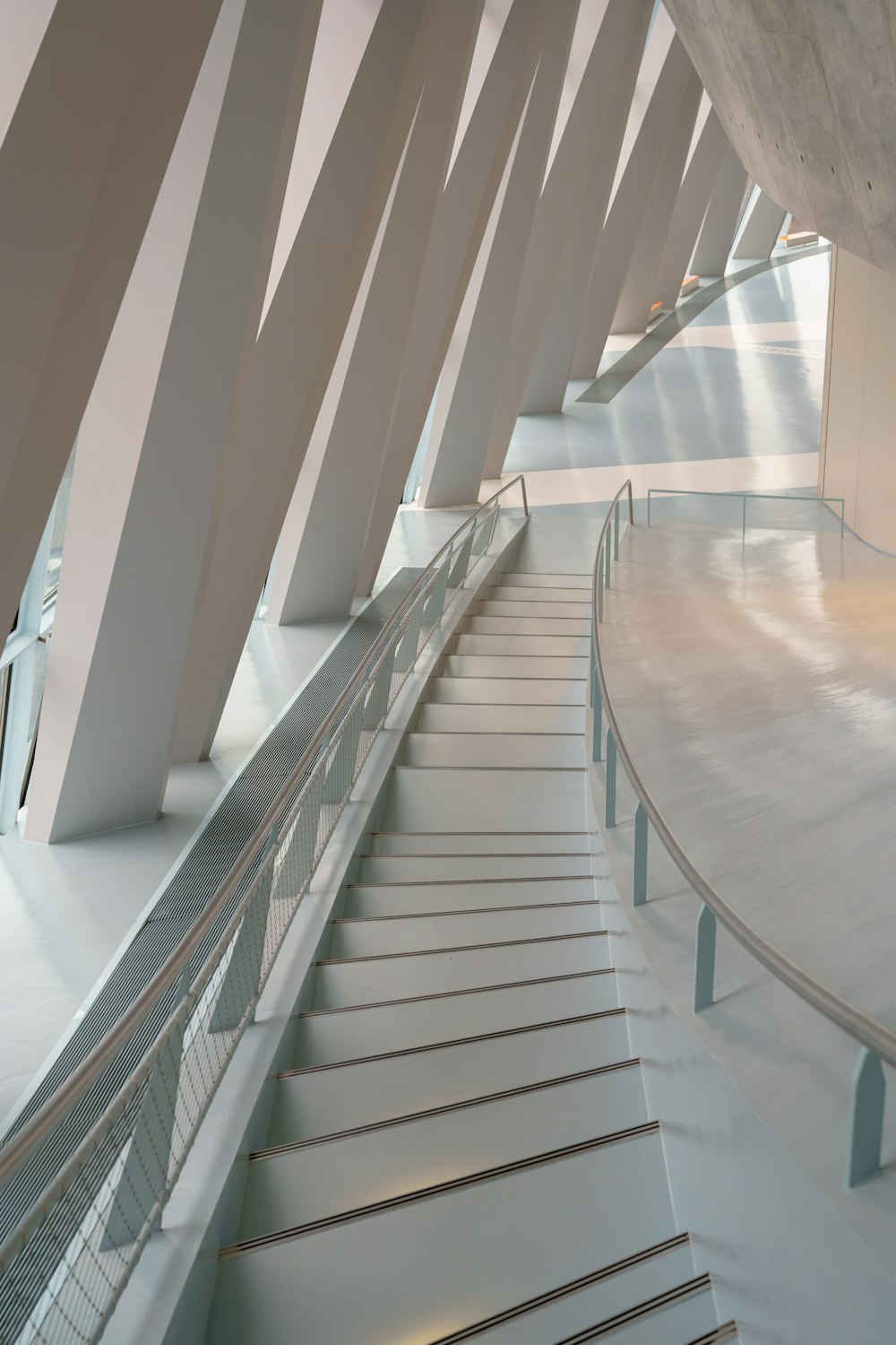 a curved staircase in a building with white walls