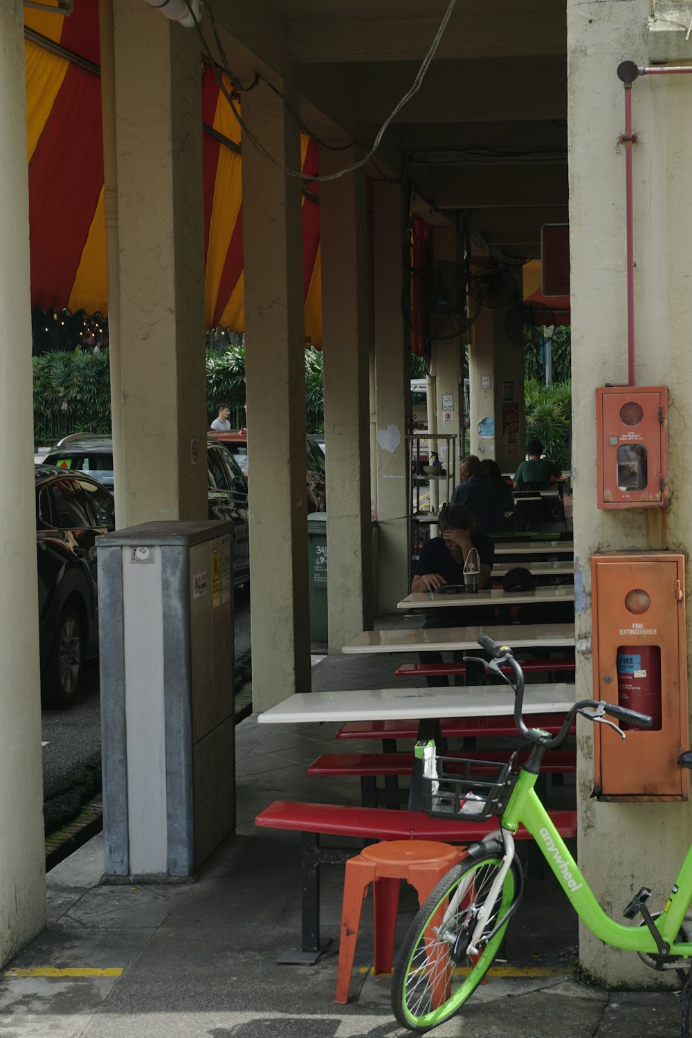 a green bike parked next to a building