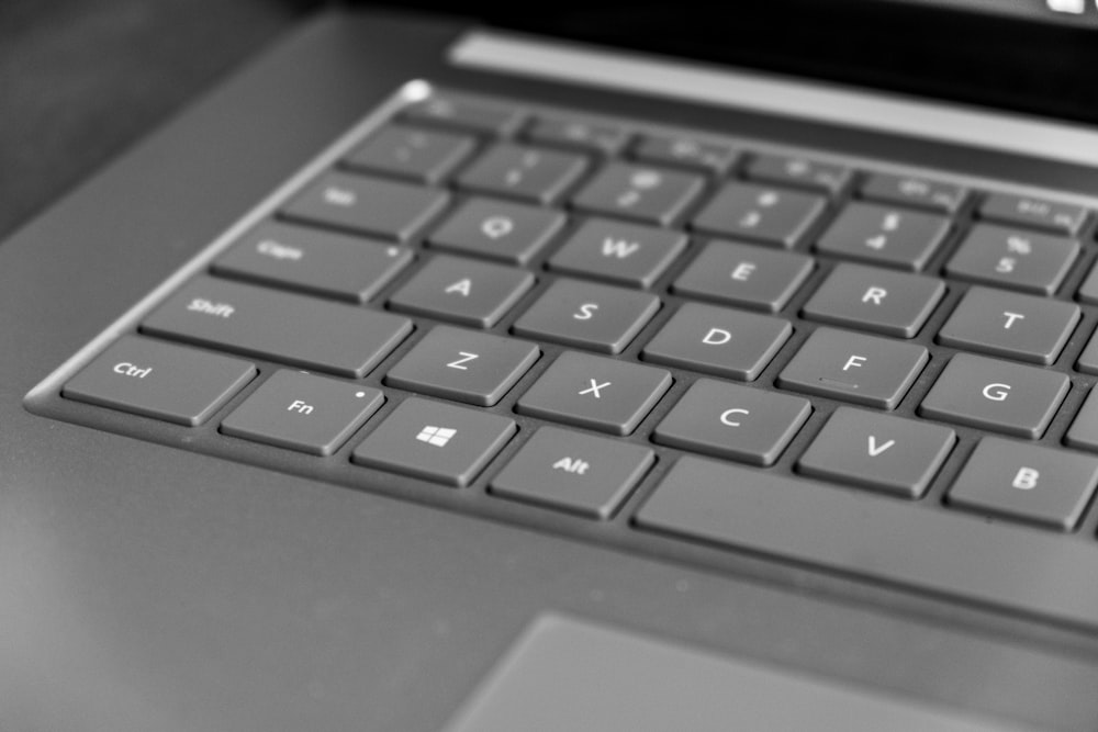 a black and white photo of a laptop keyboard