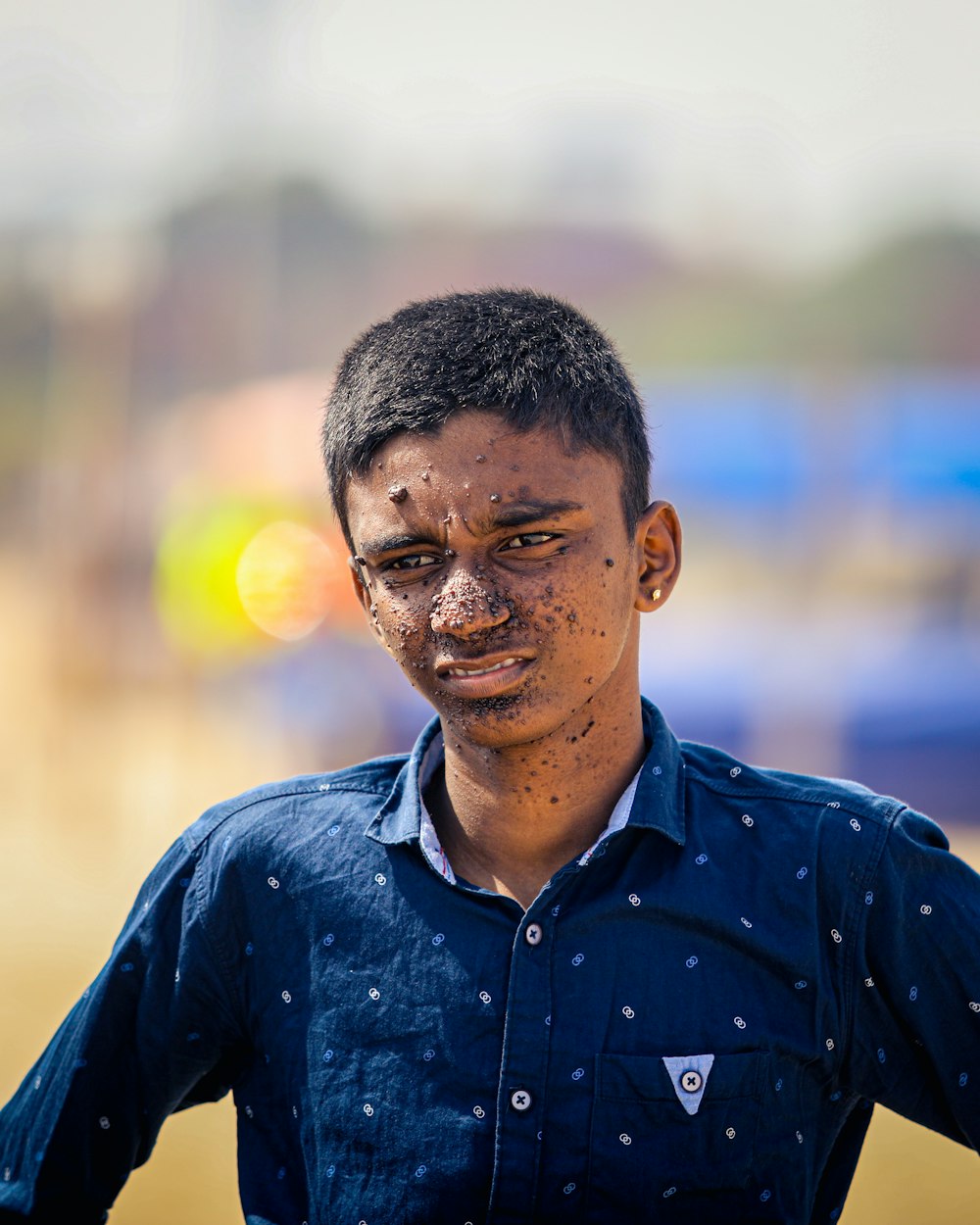 a young man with mud all over his face