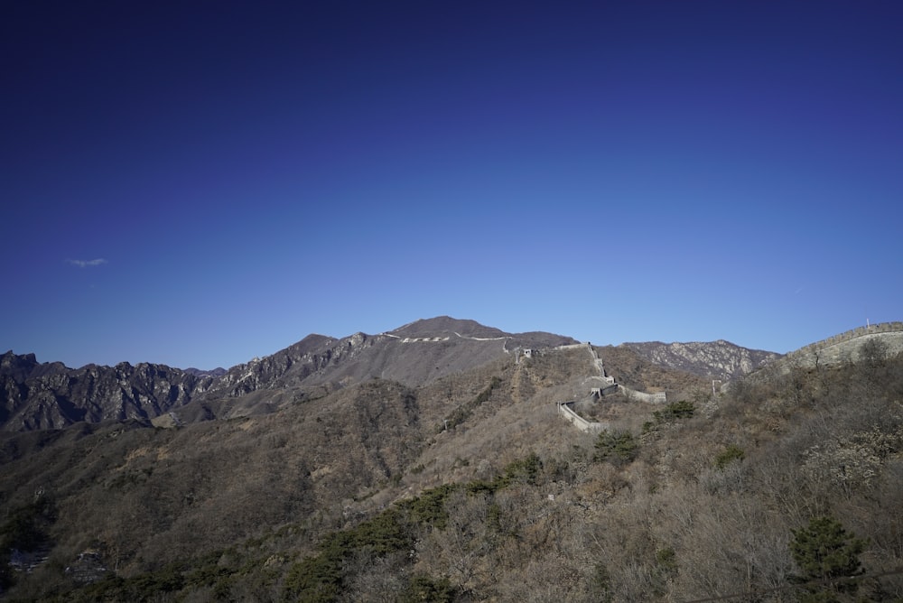 a view of the great wall of china from the top of a mountain