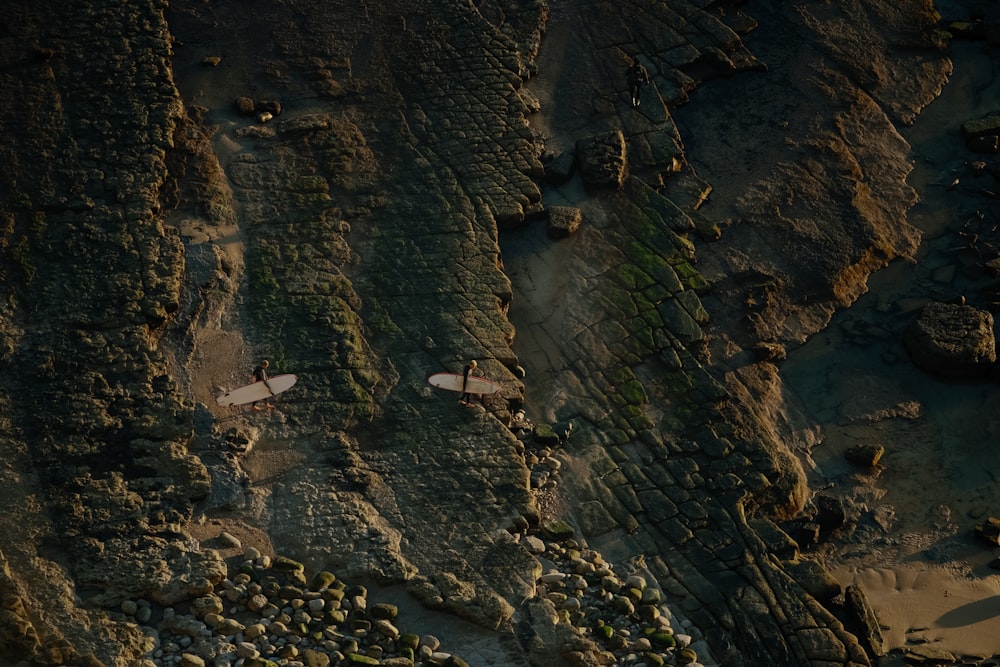 an aerial view of a beach with two surfboards