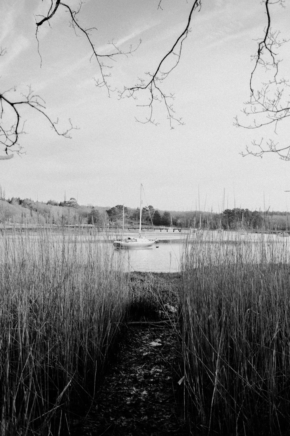 a black and white photo of a boat in the water