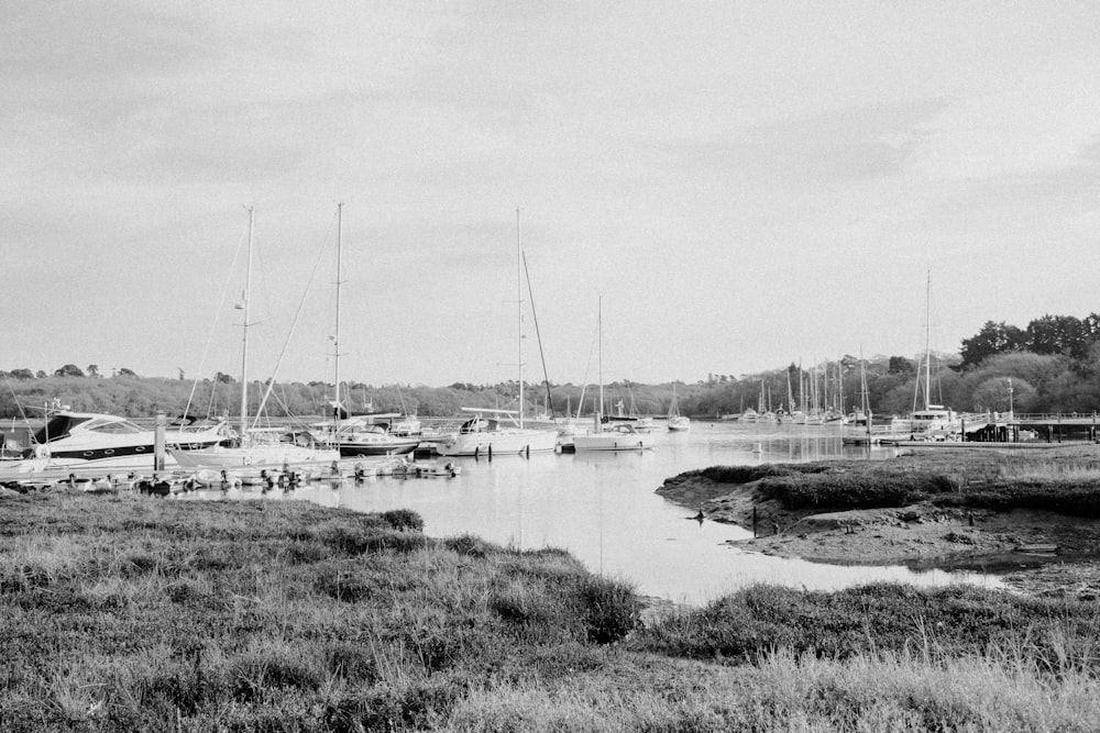 a black and white photo of boats in a harbor