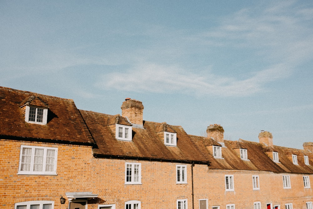 a row of brick buildings with white windows