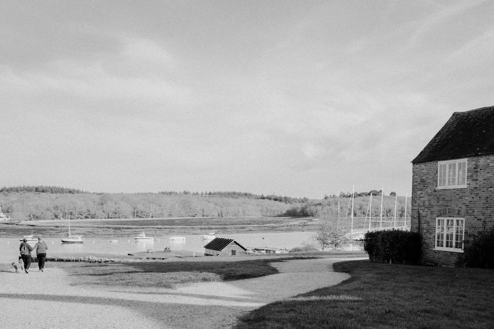 a black and white photo of people walking on a path