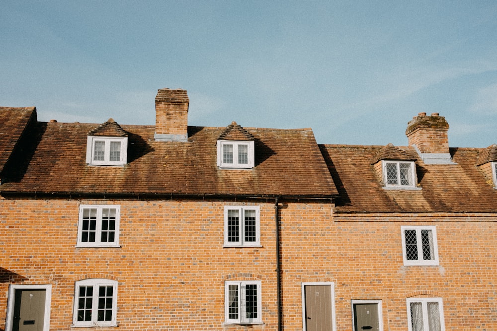 a brick building with a clock on the front of it