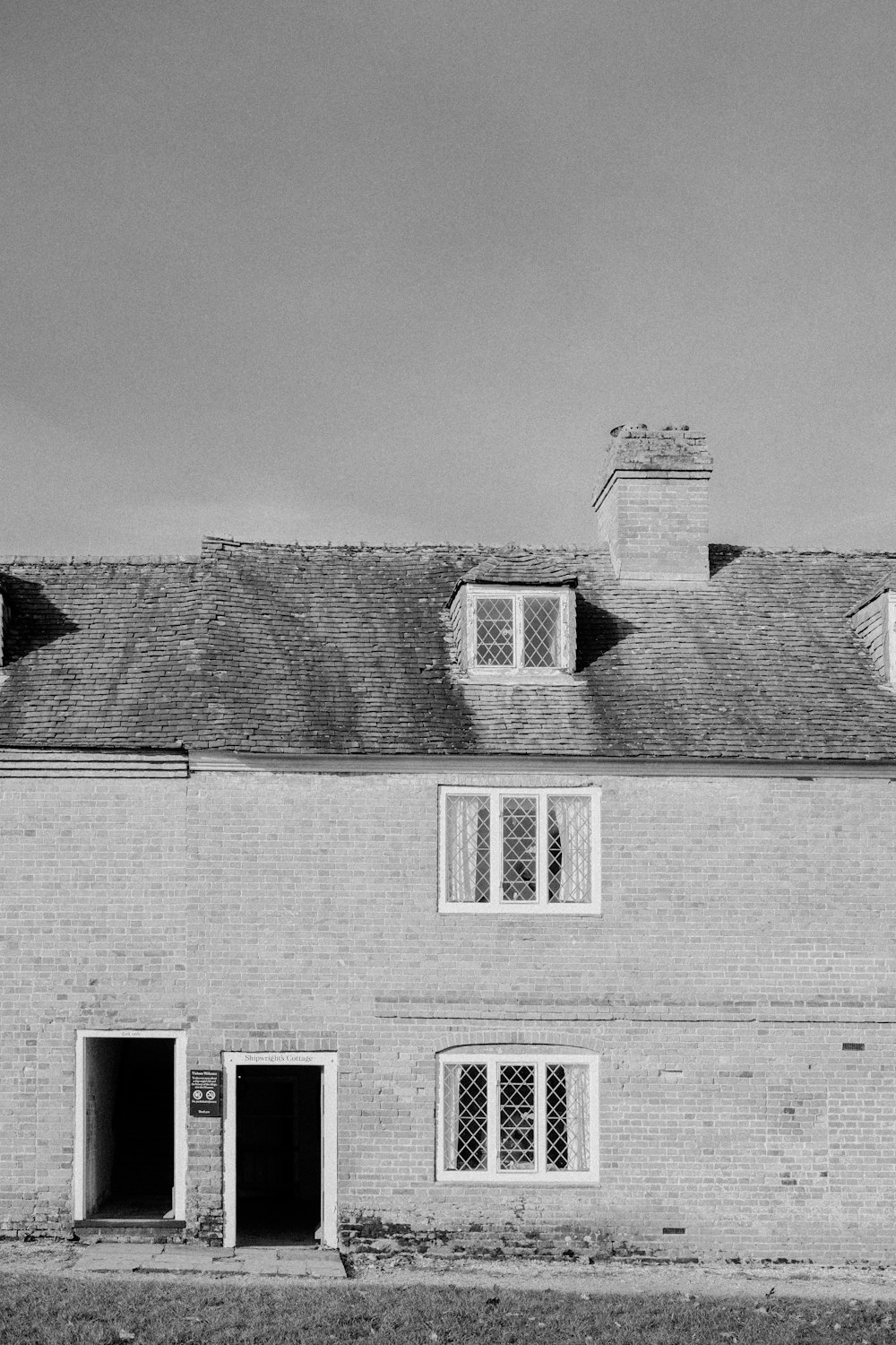 a black and white photo of a brick house