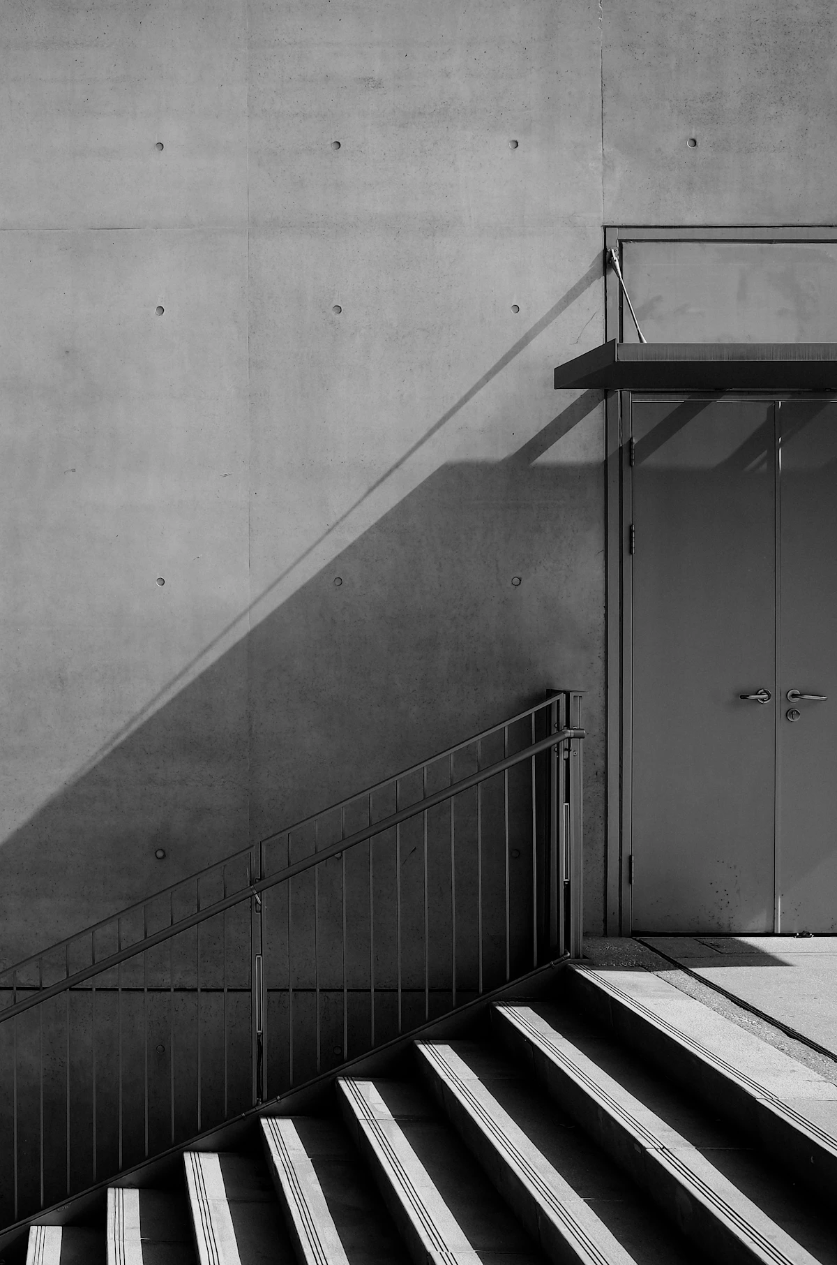 A concrete staircase cut by diagonal light