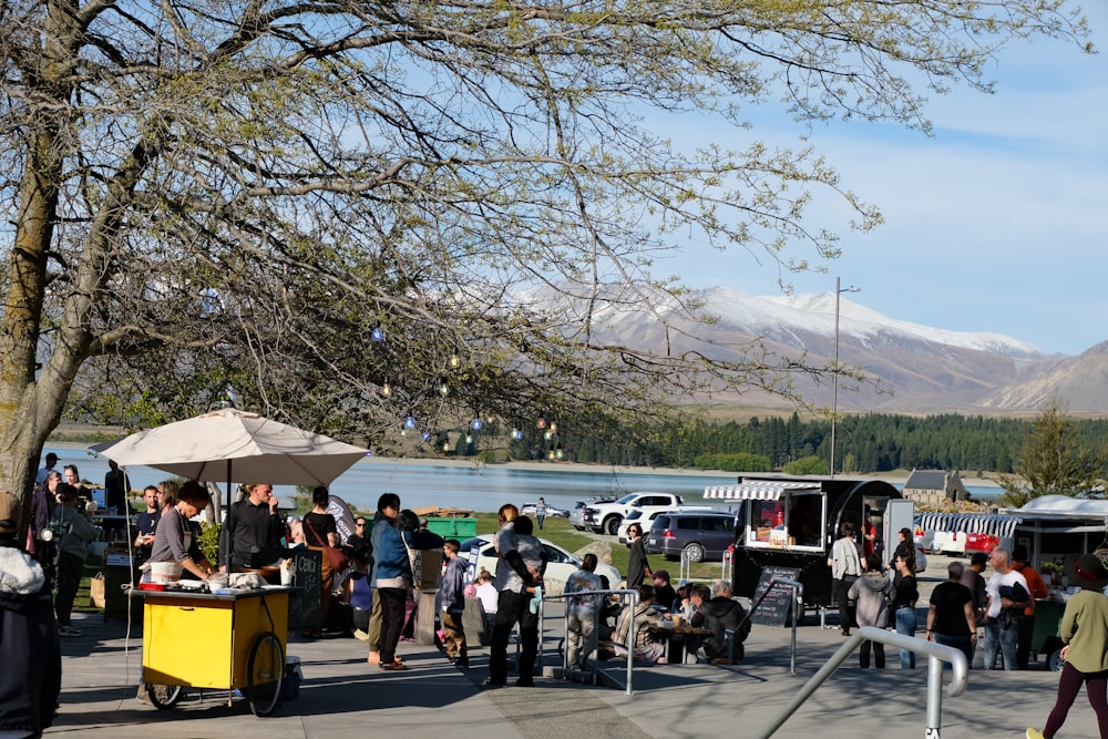 a group of people standing around a yellow cart