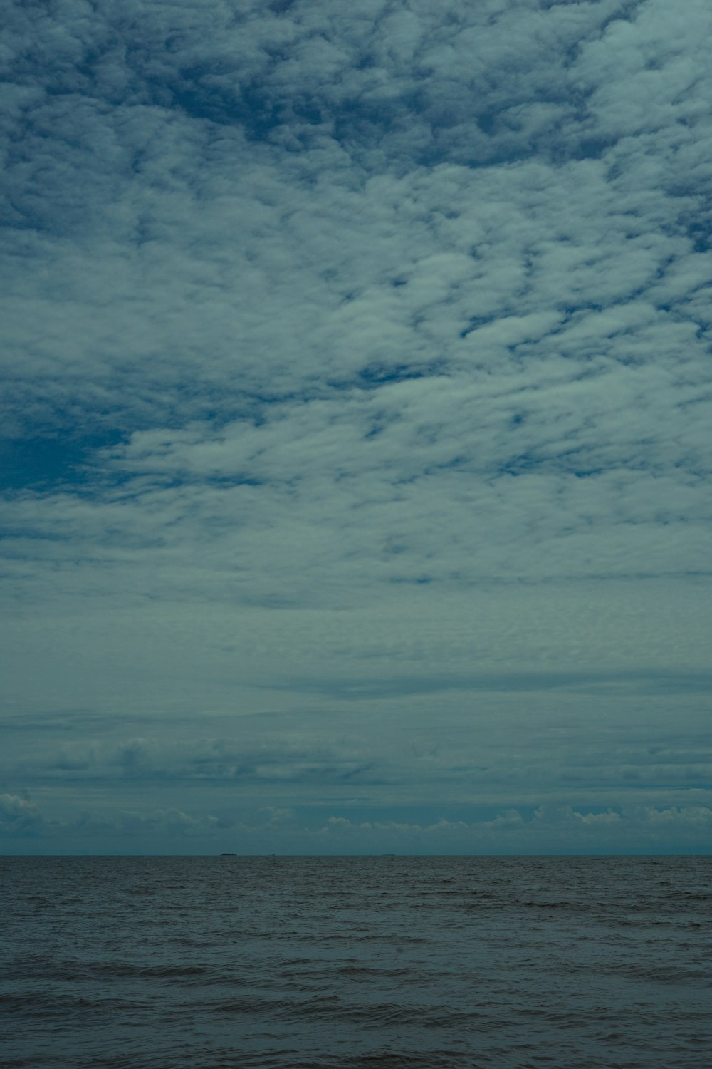 a large body of water under a cloudy sky