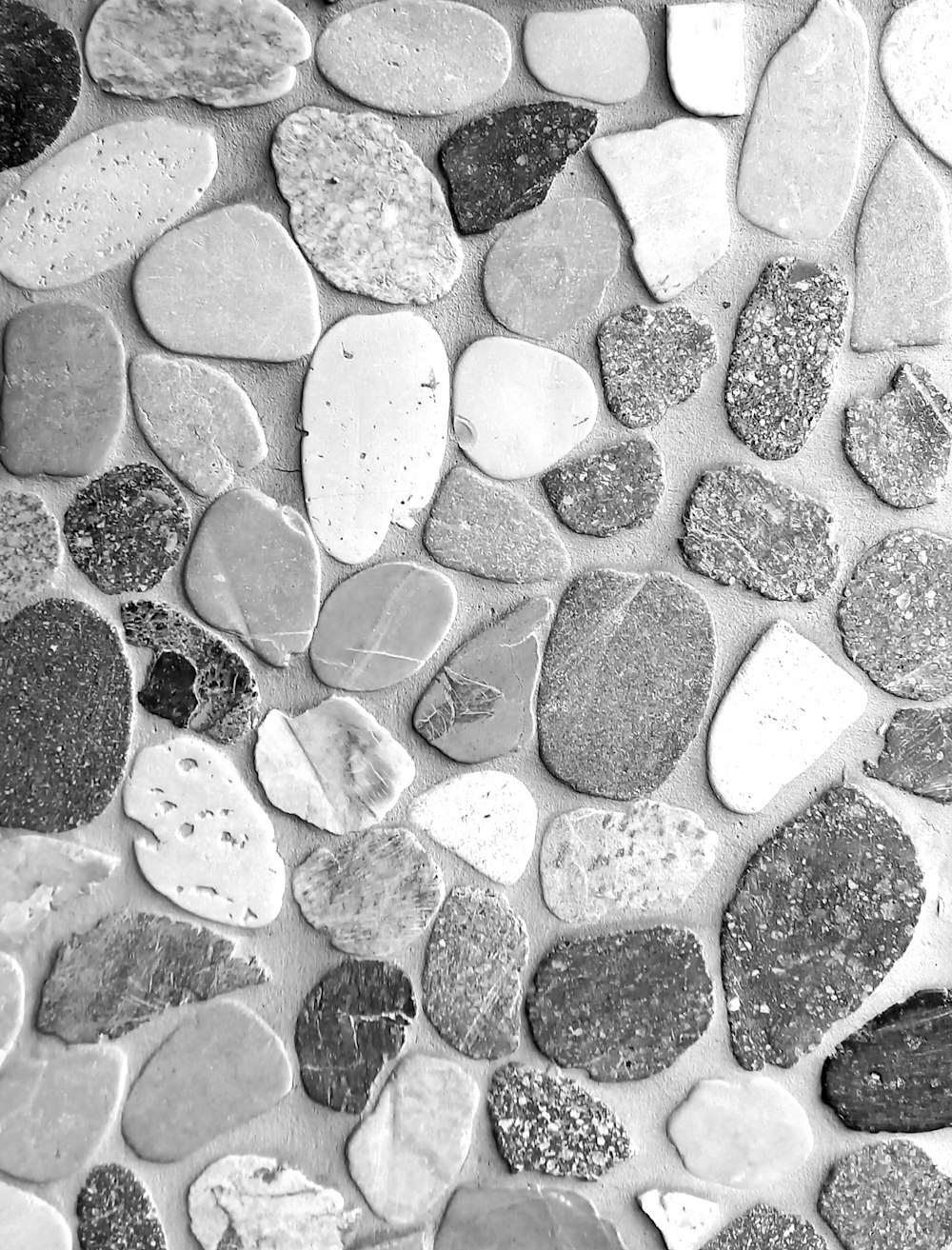 a black and white photo of rocks and gravel