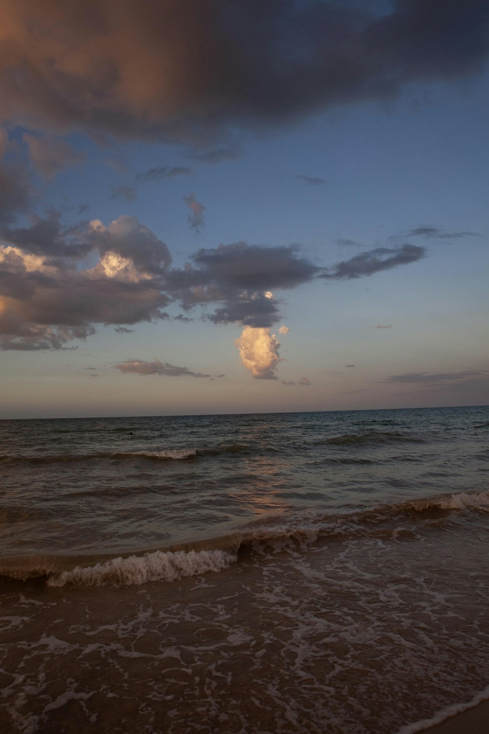 a beach with waves coming in to shore